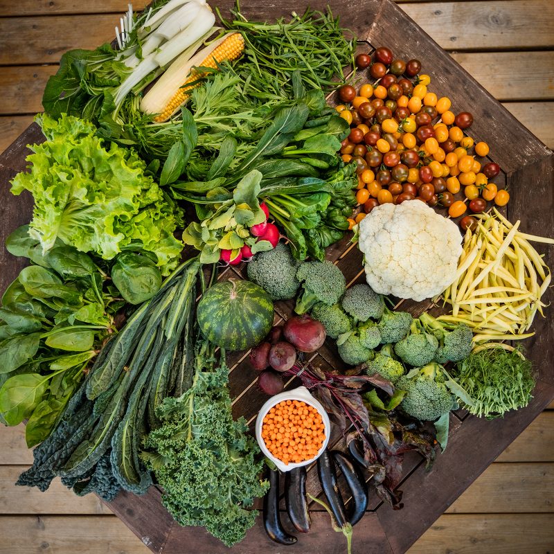 Different green vegetables lying on a tabletop