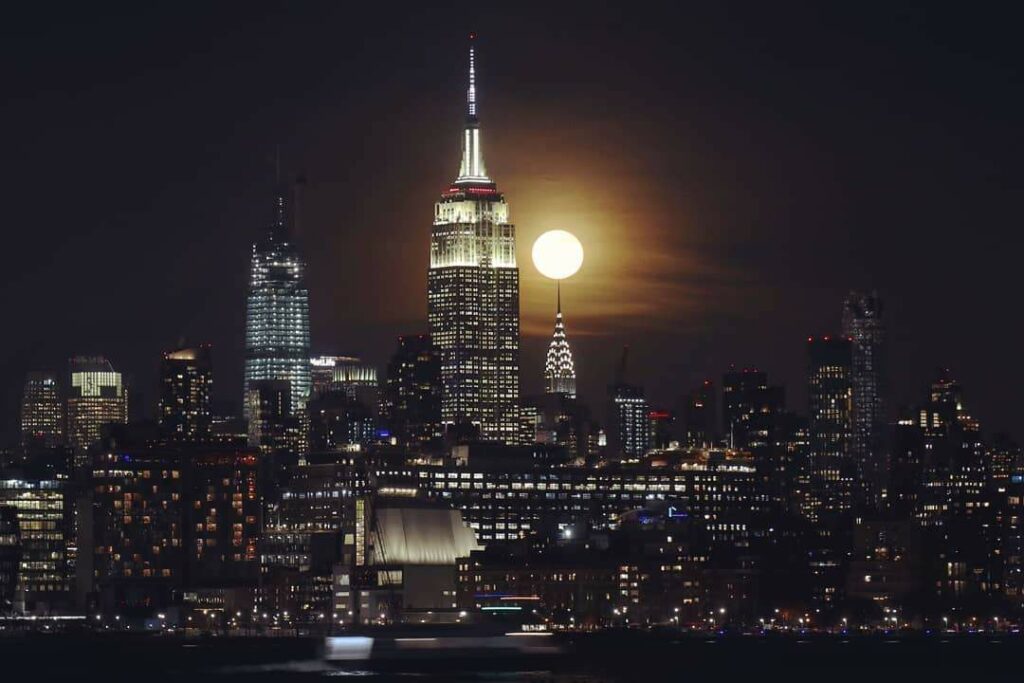 The Cold Moon sits atop the Chrysler Building as it rises next to the Empire State Building in New York City tonight.