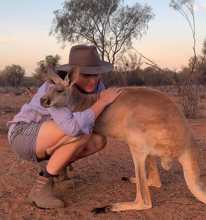 A woman comforts a Kangaroo. Australia is home to many species of wild animals.