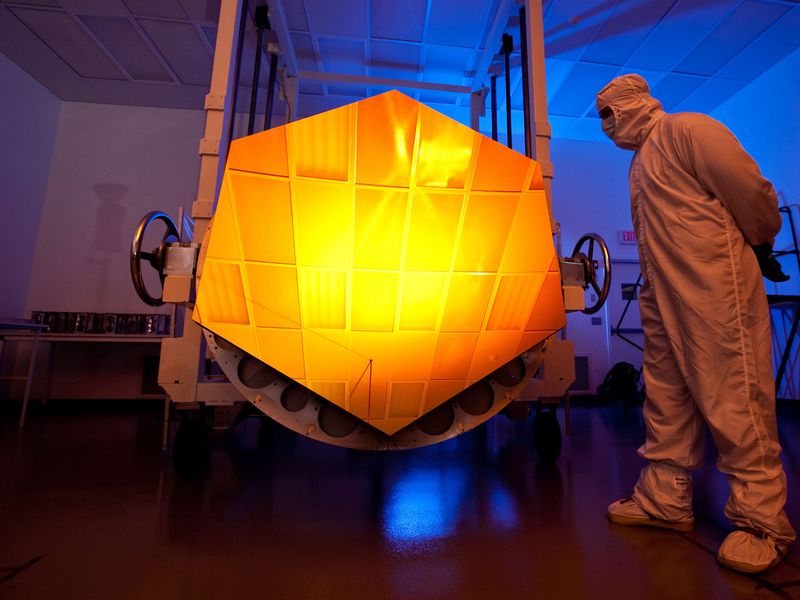 Photo 3: A thin layer of gold on each of the JWST’s 18 mirror segments reflects mostly infrared light. (Drew Noel/NASA) 