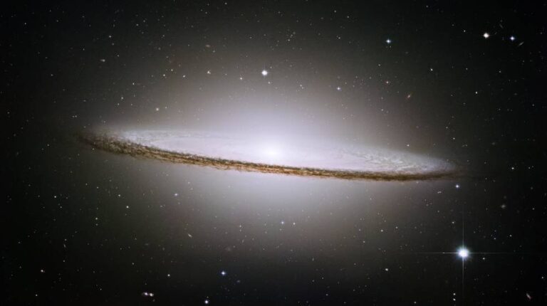 Hubble space telescope optical image of M104 (The Sombrero Galaxy). The diffuse glow is the combined light of billions of stars residing within the galaxy. The dark dust lanes surrounding the edge of the galaxy block some of the optical light from reaching us. Image credit: nasa.gov.